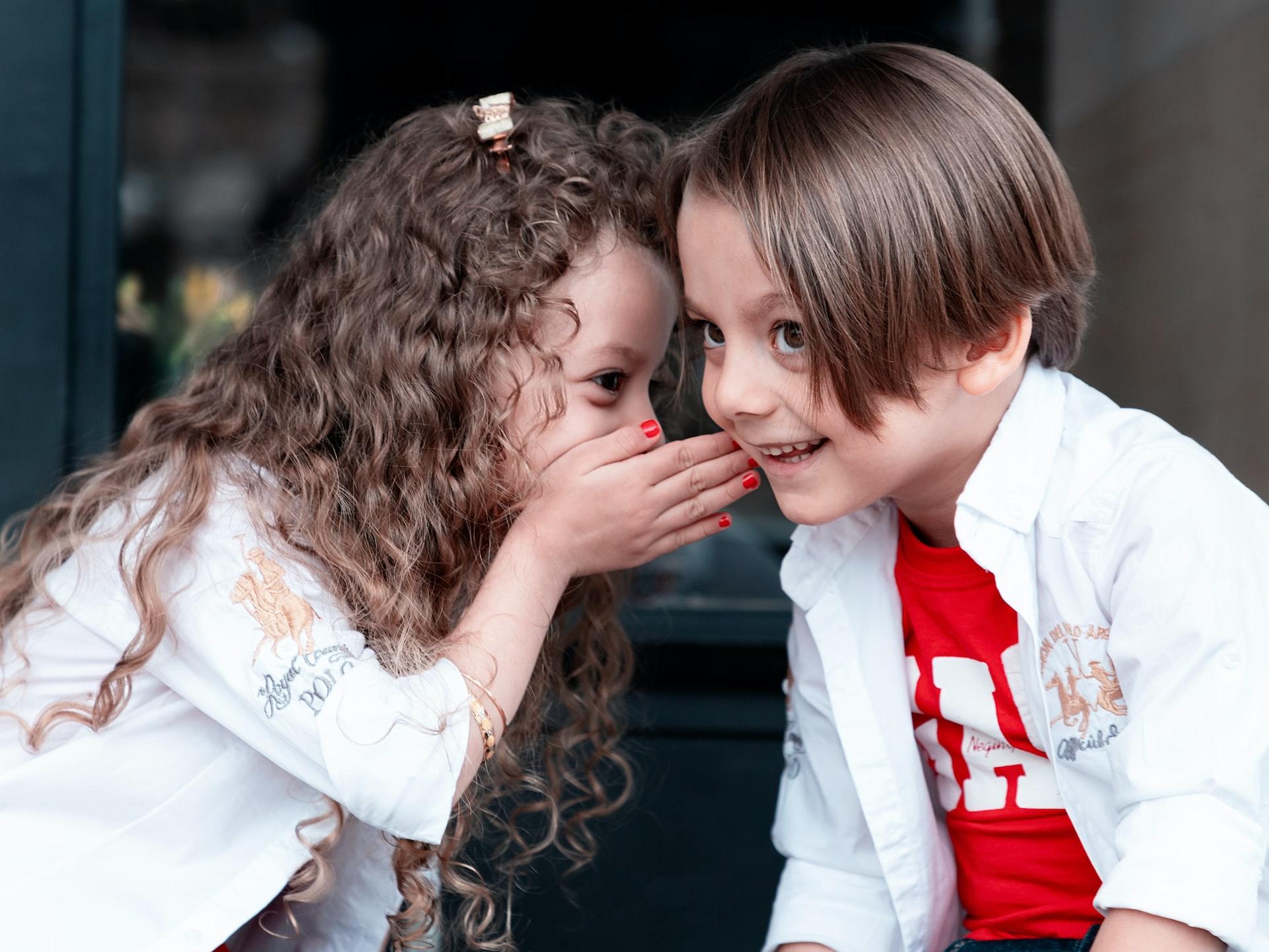 woman in white long sleeve shirt kissing girl in white long sleeve shirt